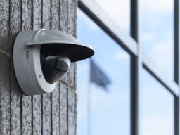 M3215-LVE wall mount outside with blue sky. from AXIS COMMUNICATIONS