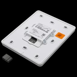 White volume controller for wall mount. C8310 is from Axis Communications - viewed from its right angle